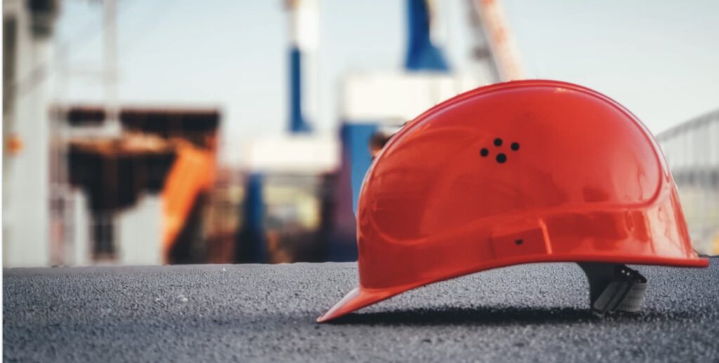 Construction site with red helmet. 